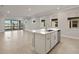 Open living area with tile floors, kitchen island, and access to a patio at 11267 Boundless Ter, Venice, FL 34293