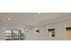 Bright living room with large windows, offering a view of the water at 11267 Boundless Ter, Venice, FL 34293