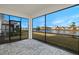 Screened porch overlooking a lake with paver tile flooring at 11267 Boundless Ter, Venice, FL 34293