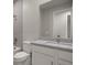 Clean bathroom with white vanity and gray tile at 11275 Boundless Ter, Venice, FL 34293