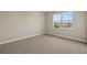 Simple bedroom with grey carpet and a window offering a lake view at 11275 Boundless Ter, Venice, FL 34293