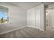 Bright bedroom with a large window, carpet, and double door closet at 11275 Boundless Ter, Venice, FL 34293