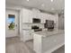 Modern kitchen with white cabinets, stainless steel appliances, and an island at 11275 Boundless Ter, Venice, FL 34293