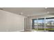 Living room with sliding doors and view of lake from back patio at 11275 Boundless Ter, Venice, FL 34293