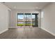 Living room with sliding glass doors offering a lake view at 11275 Boundless Ter, Venice, FL 34293