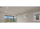 Living area with sliding doors leading to a backyard patio overlooking a lake at 11275 Boundless Ter, Venice, FL 34293