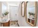 Bright entryway featuring hardwood floors, a white front door, and stylish decorative mirrors at 4584 Stargazer Ct, Palm Harbor, FL 34683