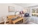 Dining area with a natural wood table, bench seating, and stylish decor, connecting to the living space at 4588 Stargazer Ct, Palm Harbor, FL 34683