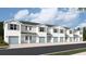Row of modern townhomes with attached garages and coordinated shutters, creating a cohesive street view at 4592 Pleasant Ave, Palm Harbor, FL 34683