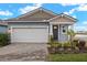 One-story home with a two-car garage and attractive landscaping at 12158 Meditation Trl, Venice, FL 34293