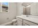 Modern bathroom featuring a sleek vanity with solid surface countertops and a stylish tiled shower at 17909 Solstice Ave, Venice, FL 34293