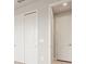 Bright hallway featuring two closets with sliding doors for optimal storage and organization at 17909 Solstice Ave, Venice, FL 34293