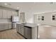 Contemporary kitchen with an island, stainless steel appliances, and tiled flooring at 17909 Solstice Ave, Venice, FL 34293