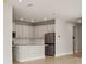 An open concept kitchen with white cabinets, stainless steel appliances, and center island at 17909 Solstice Ave, Venice, FL 34293