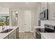 Bright kitchen featuring stainless steel appliances, gray cabinets, and subway tile backsplash at 17909 Solstice Ave, Venice, FL 34293