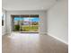 Bright living room features sliding glass doors providing natural light and community views at 17909 Solstice Ave, Venice, FL 34293