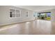 Bright and airy living room with tiled flooring and sliding glass doors to the backyard at 17909 Solstice Ave, Venice, FL 34293