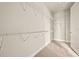 Walk-in closet with white wire shelving and neutral carpeting at 17909 Solstice Ave, Venice, FL 34293