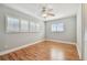 Bedroom with wood floors, window with shutters, and ceiling fan at 936 79Th S St, St Petersburg, FL 33707