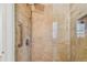 Walk-in shower with marble tile and rain shower head at 936 79Th S St, St Petersburg, FL 33707