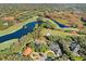 Aerial view of the property highlighting the pool, large lot, proximity to the golf course, and waterfront views at 16407 Zurraquin De Avila, Tampa, FL 33613