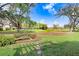 Serene backyard view of the golf course with mature trees, a small water feature, and stone path at 16407 Zurraquin De Avila, Tampa, FL 33613