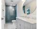 Stylish bathroom featuring a walk-in shower with mosaic tiles and marble countertop sink at 16407 Zurraquin De Avila, Tampa, FL 33613