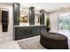 Bathroom featuring marble countertops, dual vanities, and elegant decor at 16407 Zurraquin De Avila, Tampa, FL 33613