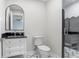 Well-lit bathroom featuring a pedestal sink, toilet, and a glass enclosed shower at 16407 Zurraquin De Avila, Tampa, FL 33613