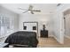 Cozy bedroom with a ceiling fan, shuttered windows, and wood flooring at 16407 Zurraquin De Avila, Tampa, FL 33613