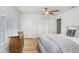 Serene bedroom showcasing a cozy bed, wooden dresser, and shutters for natural light control at 16407 Zurraquin De Avila, Tampa, FL 33613