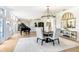 Elegant dining area with modern chandelier, piano, and large windows at 16407 Zurraquin De Avila, Tampa, FL 33613