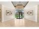 Bright foyer featuring a modern chandelier, herringbone wood floors, and double glass doors to the front yard at 16407 Zurraquin De Avila, Tampa, FL 33613