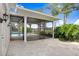 Covered patio with stone flooring, leading to a screened-in lanai and backyard pool at 16407 Zurraquin De Avila, Tampa, FL 33613