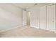 This bedroom features neutral paint, carpet and closet with bright white doors at 17938 Solstice Ave, Venice, FL 34293