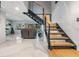 Modern metal staircase with wood accents leading to the upper level at 215 Woods Landing Trl, Oldsmar, FL 34677