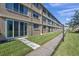 Condo building exterior showcasing a walkway and well-maintained lawn at 4915 Bay Ne St # 123, St Petersburg, FL 33703