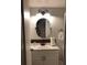 Updated bathroom with an oval mirror and modern vanity at 11708 Rolling Oaks Ln, Tampa, FL 33618