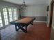 Spacious game room with a pool table and access to the backyard at 11708 Rolling Oaks Ln, Tampa, FL 33618