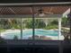 Inviting kidney-shaped pool with wooden patio furniture at 11708 Rolling Oaks Ln, Tampa, FL 33618