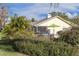 Relaxing patio with seating area, umbrella, and lush landscaping at 435 Palmdale Dr, Oldsmar, FL 34677