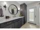 Modern bathroom with dark gray vanity, quartz countertop, and exterior access at 435 Palmdale Dr, Oldsmar, FL 34677