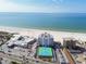 Aerial view showing condo building, beach, ocean, and tennis courts at 4950 Gulf Blvd # 206, St Pete Beach, FL 33706