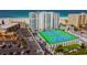 Aerial view of condo building with tennis courts and beach access at 4950 Gulf Blvd # 206, St Pete Beach, FL 33706