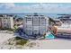 Aerial view of beachfront building with pool and beach access at 4950 Gulf Blvd # 206, St Pete Beach, FL 33706