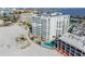 Aerial view of beachfront building with pool at 4950 Gulf Blvd # 206, St Pete Beach, FL 33706