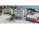 Aerial view of beachfront condo building with pool and beach access at 4950 Gulf Blvd # 206, St Pete Beach, FL 33706