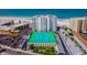 Aerial view of beachfront condo building with tennis courts and ocean views at 4950 Gulf Blvd # 206, St Pete Beach, FL 33706