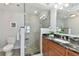 Bathroom with walk-in shower, pebble floor, and granite vanity at 4950 Gulf Blvd # 206, St Pete Beach, FL 33706