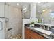 Bathroom with walk-in shower, pebble floor and granite countertop at 4950 Gulf Blvd # 206, St Pete Beach, FL 33706